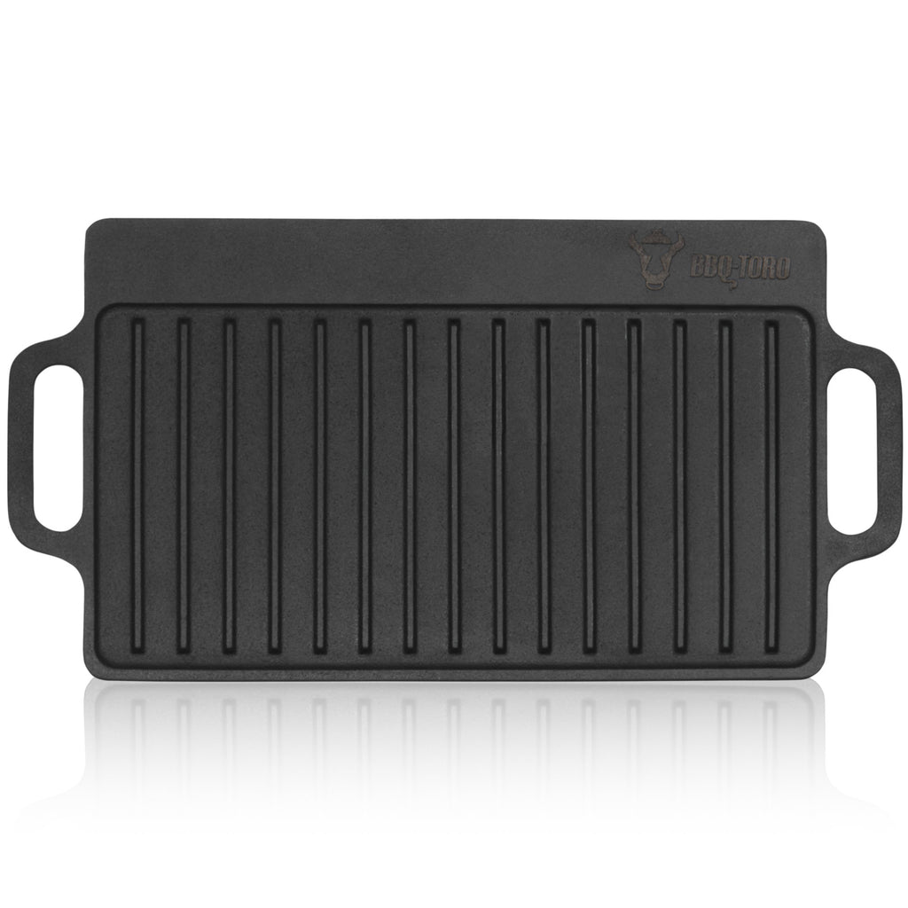 Plaque de cuisson réversible, 40 x 20,5 cm, en fonte pré-culottée, avec poignées et grille.