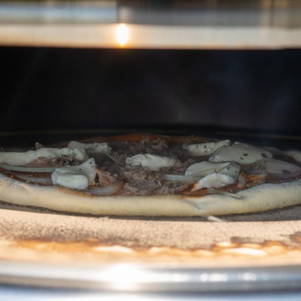 Élément à pizza, Ø 57 cm, en acier inoxydable, comprenant une pelle à pizza, une pierre à pizza et un thermomètre.