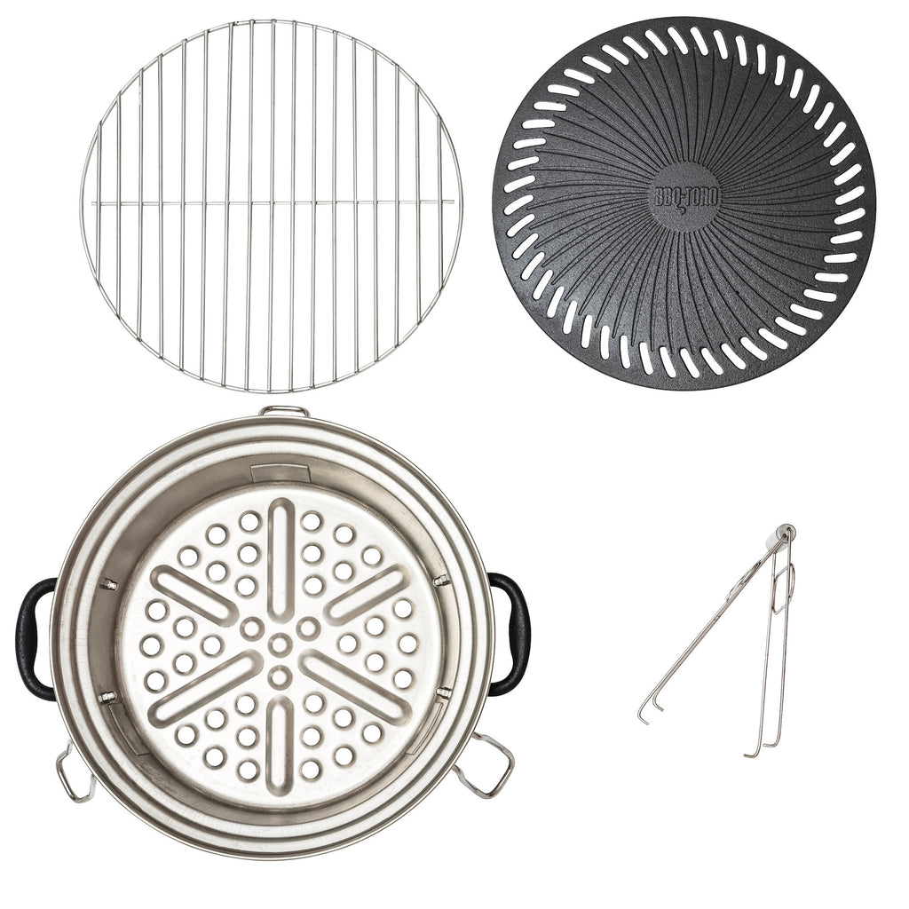 Ensemble de grilles pour poêle à fusée, comprenant une plaque de cuisson en fonte, une grille de cuisson, un bac de récupération des graisses et un lève-gril.